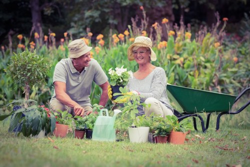 Gardener working safely with protective equipment in a De Beauvoir Town garden